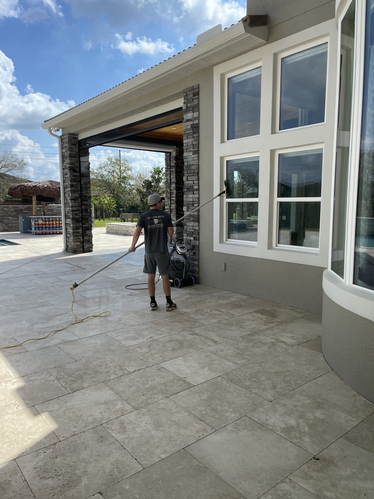 Technician cleaning the entrance windows of a community clubhouse