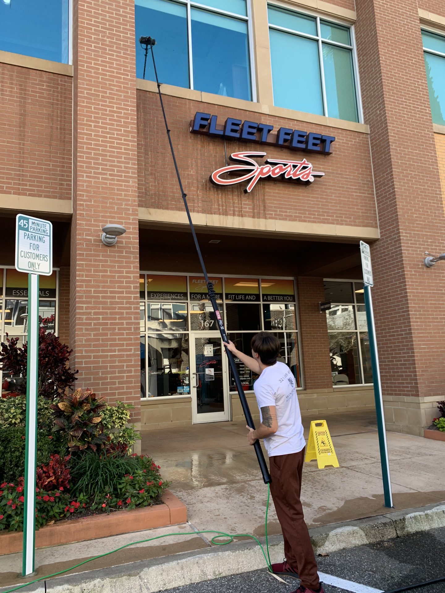 Storefront window cleaning with a water-fed pole