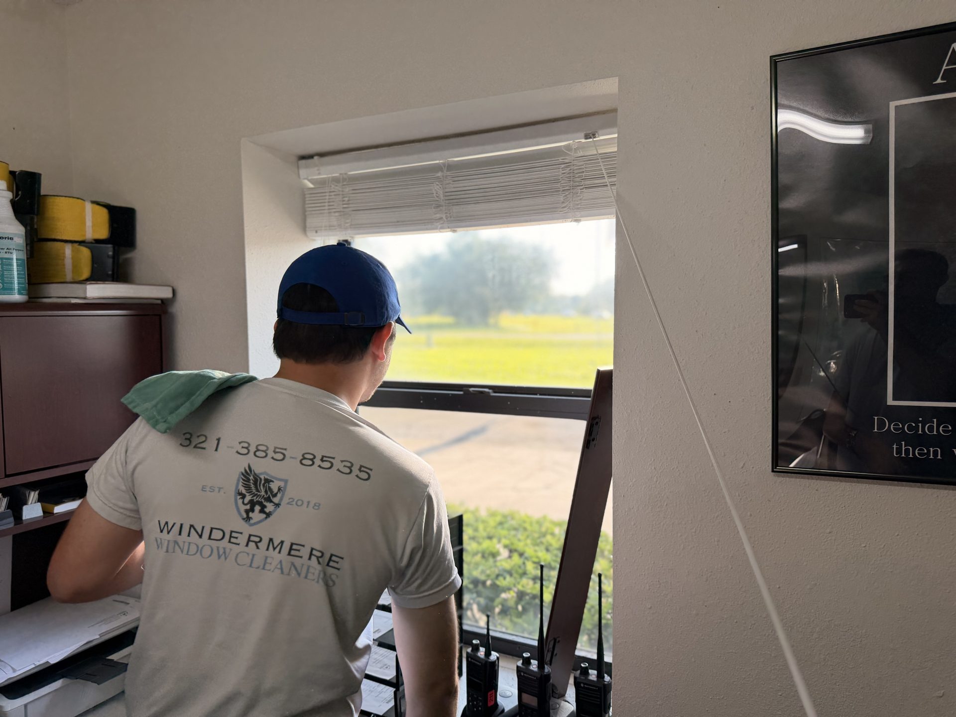 Windermere Window Cleaners technician cleaning interior office windows