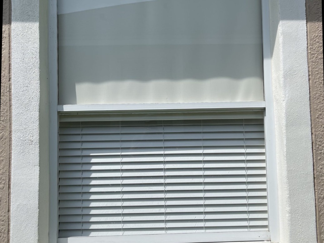The same home window after a professional window cleaning, blinds and glass clean and clear